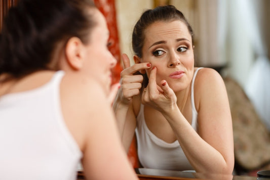 girl looking at blemish
