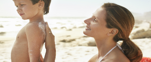 woman applying sunscreen to child